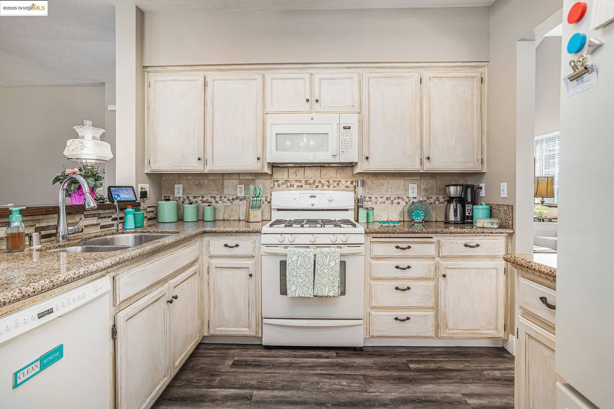 2059 Heartland Court Brentwood, CA 94513 - Photo 16 of 37 a kitchen with white cabinets and white appliances