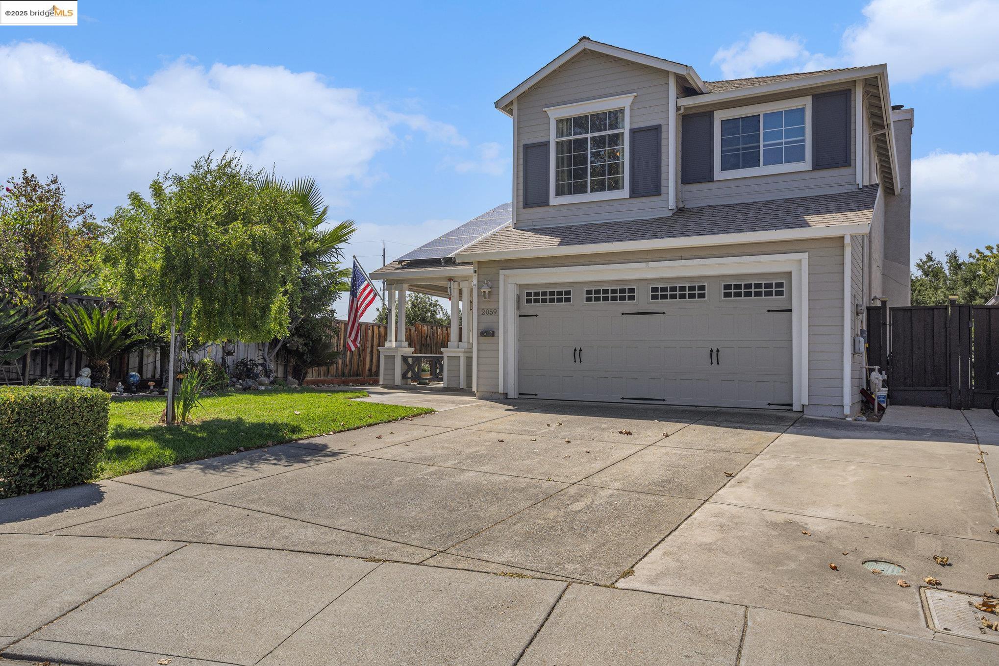 2059 Heartland Court Brentwood, CA 94513 - Photo 4 of 37 a front view of a house with a yard and garage