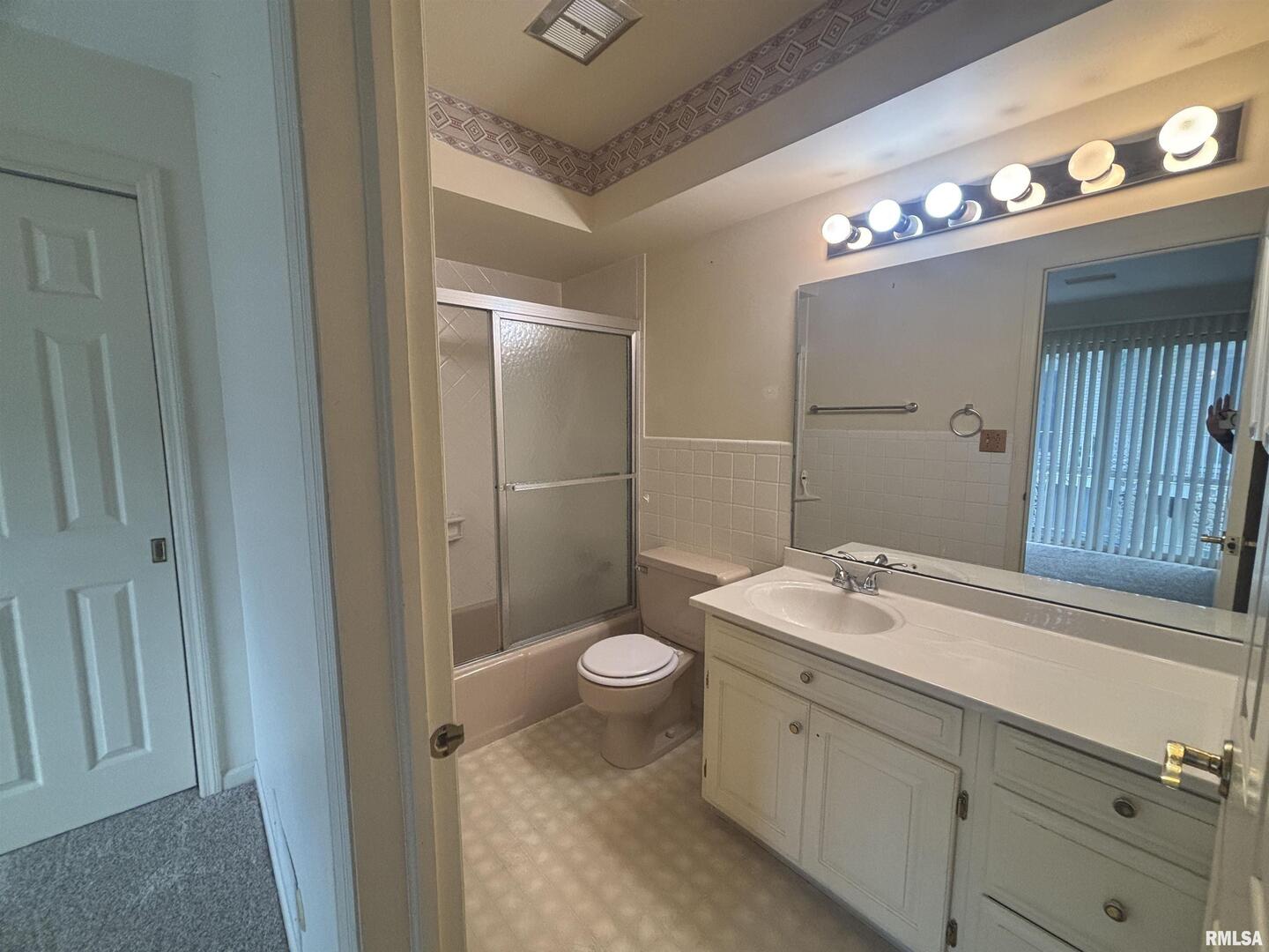 920 17th Street, Unit 28 Moline, IL 61265 - Photo 7 of 17 a bathroom with a sink a toilet a mirror and shower