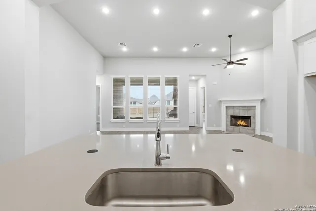 a kitchen with a sink and chandelier