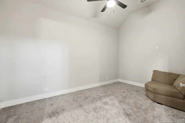an empty room with a ceiling fan