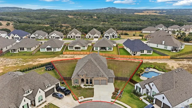 an aerial view of residential houses with outdoor space