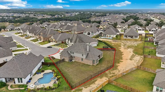 an aerial view of residential houses with outdoor space