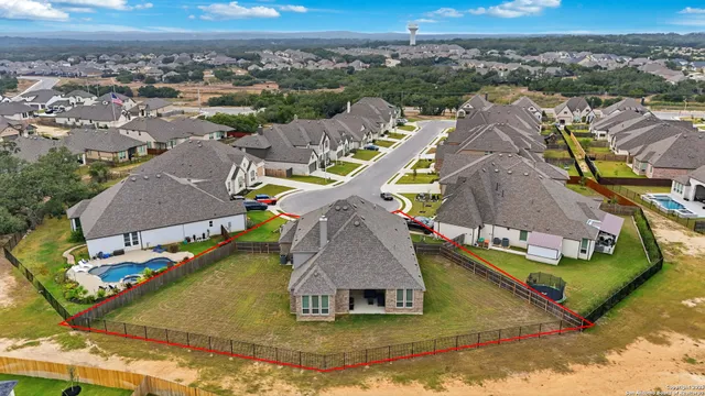 an aerial view of a house with a yard and sitting area