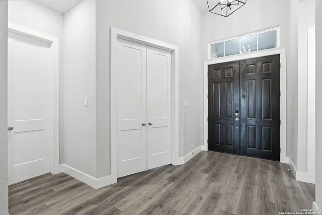 a view of a hallway with wooden floor