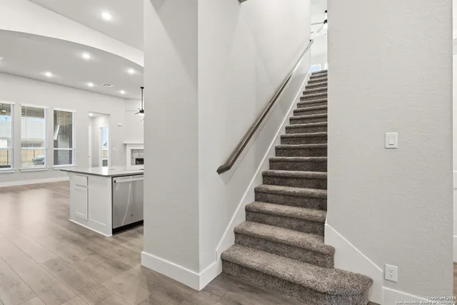 a view of an entryway with wooden floor and staircase