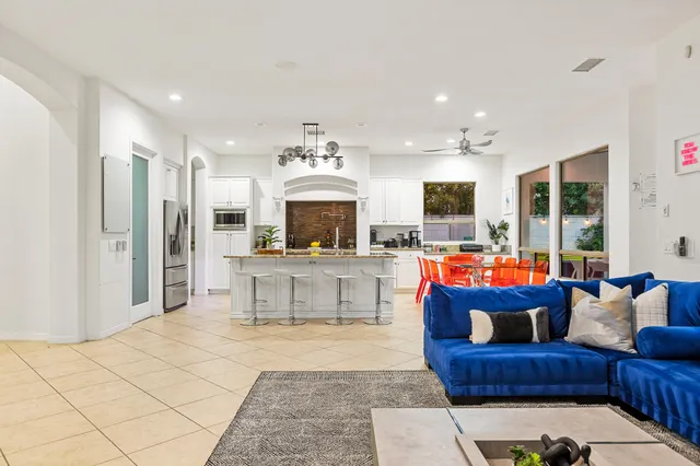 a living room with a table and a stove with wooden floor