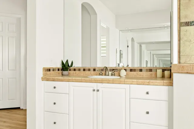 a bathroom with a sink a mirror and a bathtub