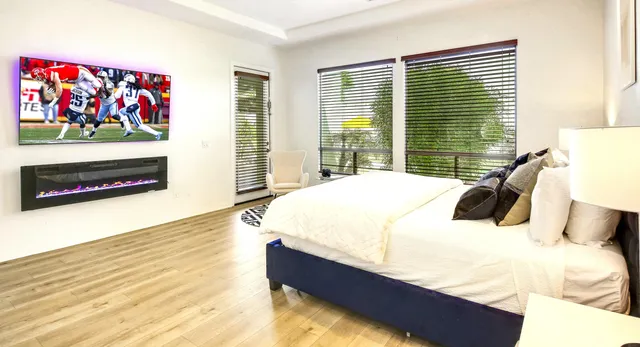 a spacious bathroom with a double vanity sink a mirror and a bathtub
