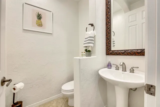 a vase of flowers sitting on a table with painted walls