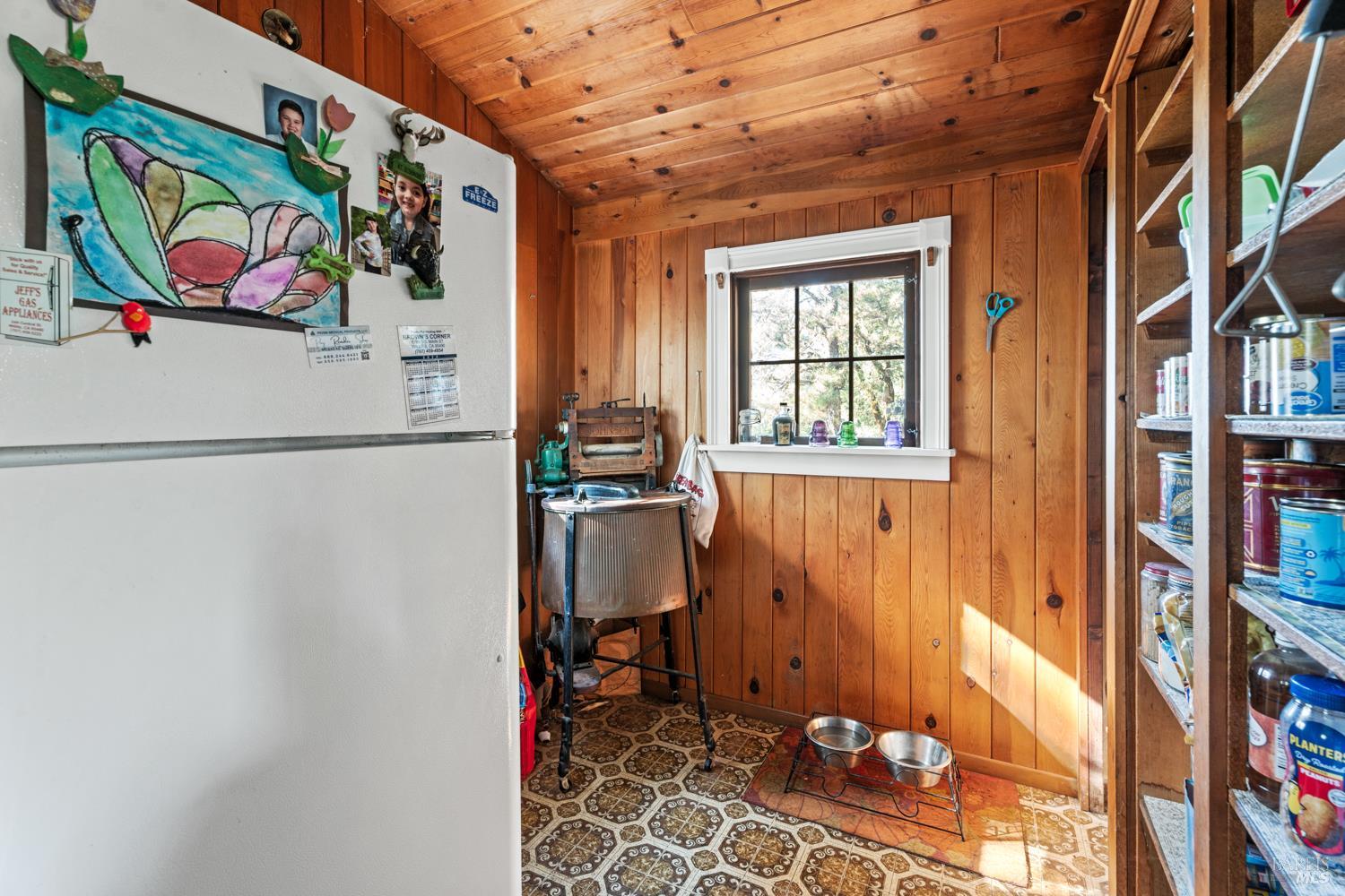 24600 String Creek Road Willits, CA 95490 - Photo 22 of 24 a kitchen with a refrigerator and a table
