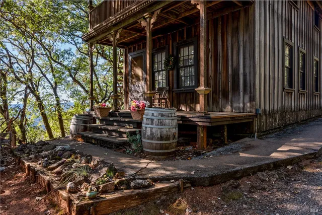 a view of a house with backyard and sitting area