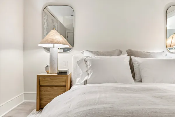 a bedroom with a bed and a night stand