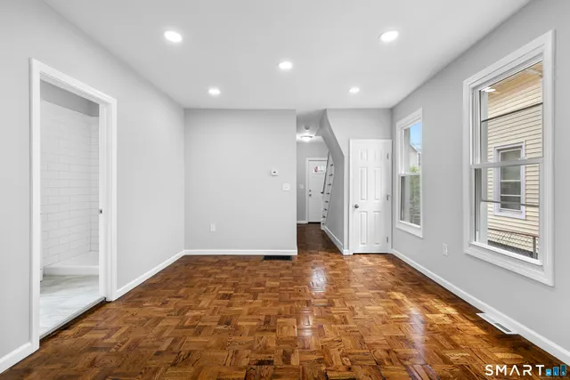 a large kitchen with kitchen island a sink stainless steel appliances and cabinets
