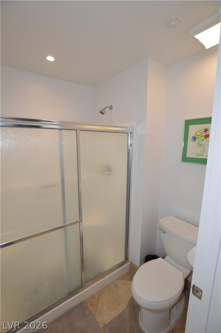 260 East Flamingo Road, Unit 332 Las Vegas, NV 89169 - Photo 11 of 36 This bathroom features a sleek glass-enclosed shower and tiled flooring, offering a fresh, modern aesthetic.
