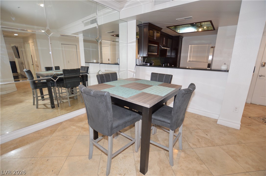 260 East Flamingo Road, Unit 332 Las Vegas, NV 89169 - Photo 3 of 36 This inviting dining area features elegant mirrored walls and sleek tile flooring.
