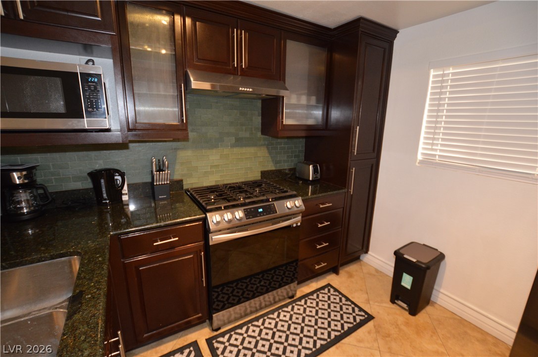 260 East Flamingo Road, Unit 332 Las Vegas, NV 89169 - Photo 5 of 36 This modern kitchen features rich cabinetry, sleek appliances, and durable countertops.