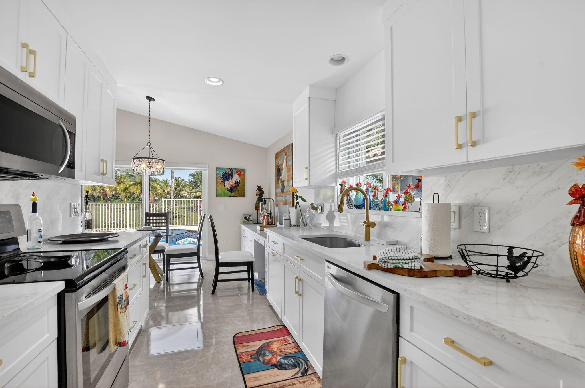 11270 Cloverleaf Circle Boca Raton, FL 33428 - Photo 17 of 98 a kitchen with lots of counter top space appliances and a center island