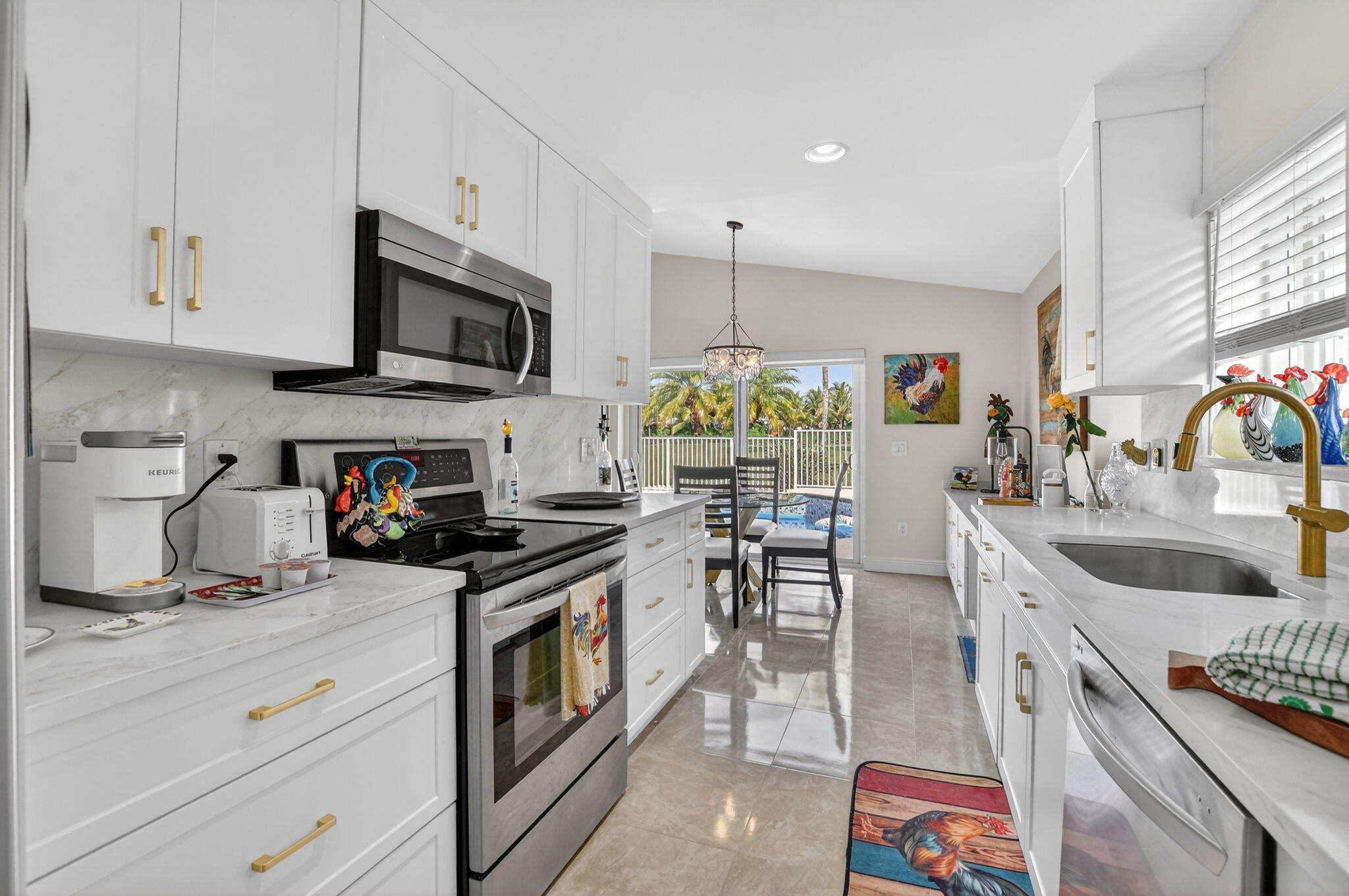 11270 Cloverleaf Circle Boca Raton, FL 33428 - Photo 19 of 98 a kitchen with stainless steel appliances granite countertop a sink stove and microwave