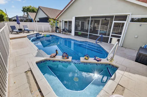 a living room with furniture kitchen view and a chandelier