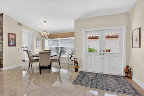 a view of a livingroom with furniture window and a kitchen