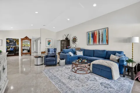 a dining room with furniture a chandelier and window