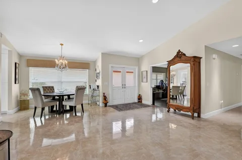 a dining room with furniture a chandelier and window