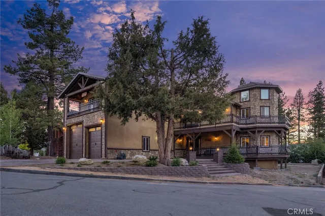 a view of a house with a tree and a yard