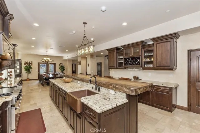 a kitchen with stainless steel appliances granite countertop a sink stove and cabinets