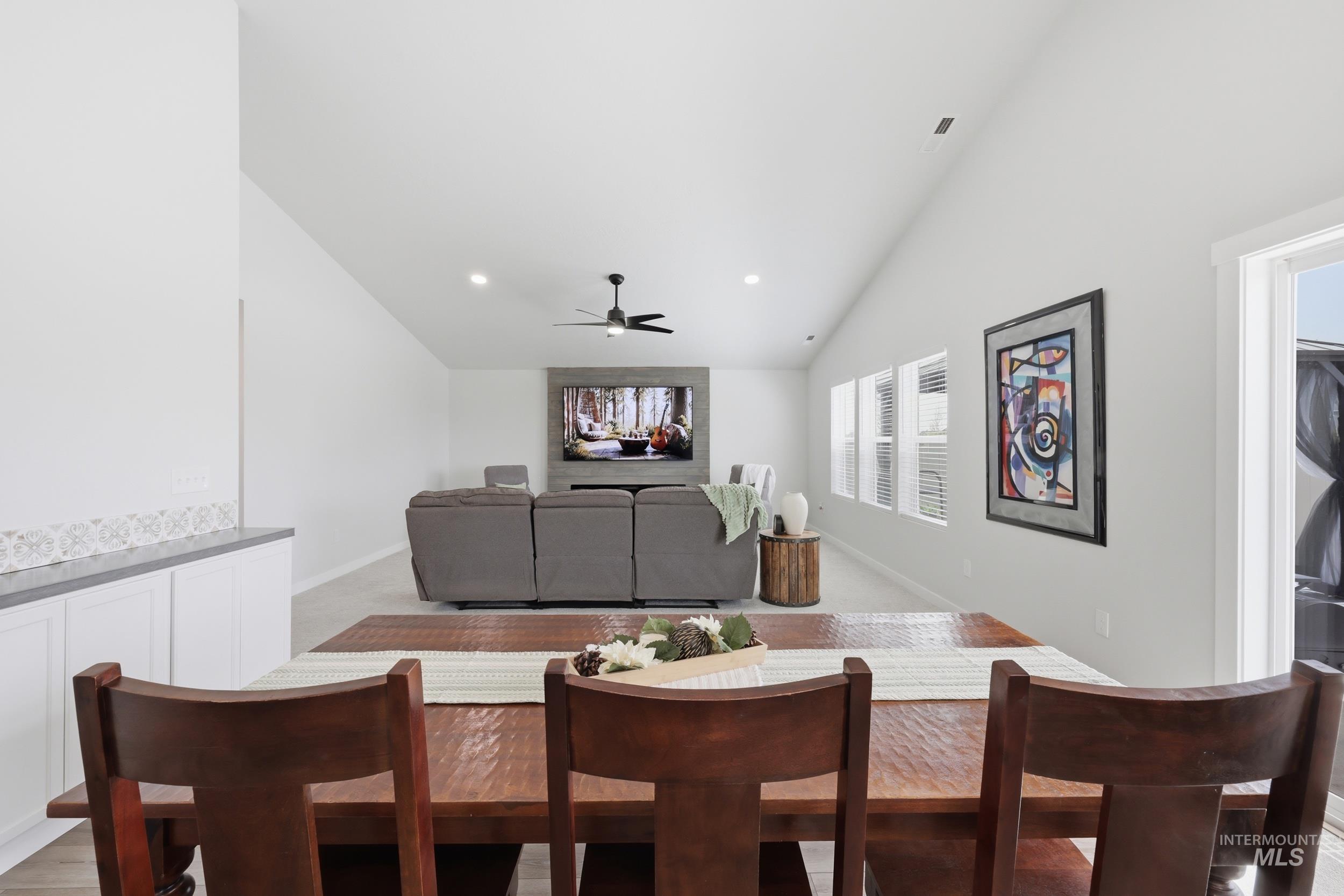 3665 W Lane Meridian, ID 83642 - Photo 13 of 42 Open-concept living space featuring a vaulted ceiling with a ceiling fan, light-toned carpeting, and recessed lighting