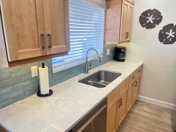 a kitchen with a sink and a stove