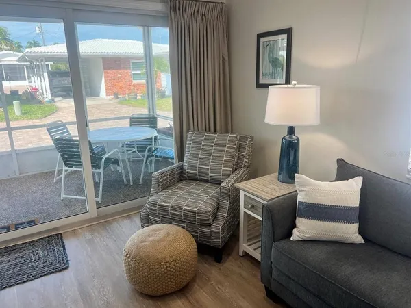 a living room with furniture and a lamp