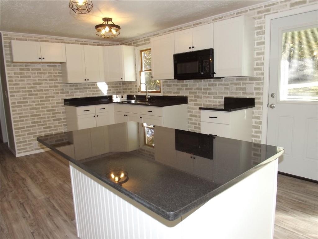 222 Harbison Road Sarver, PA 16055 - Photo 6 of 21 a kitchen with stainless steel appliances granite countertop a sink a stove top oven a counter space and cabinets