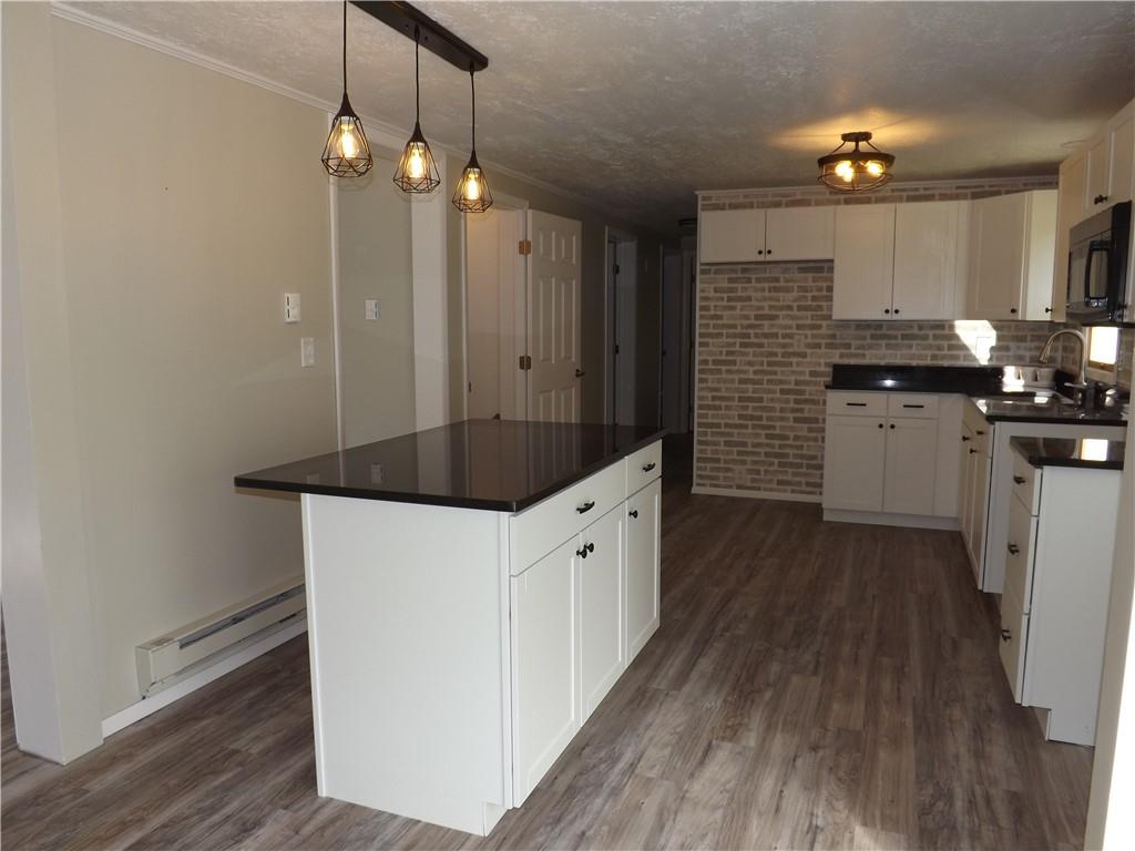 222 Harbison Road Sarver, PA 16055 - Photo 7 of 21 a kitchen with a sink a refrigerator and white cabinets