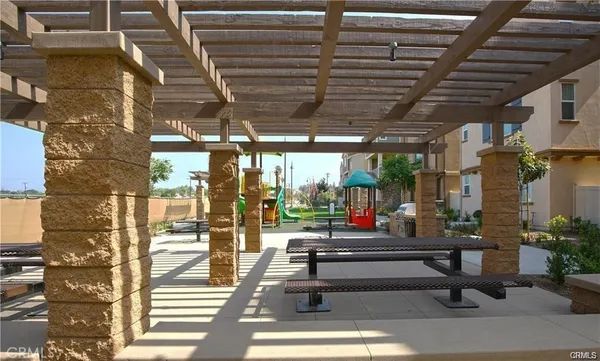 a room with lots of furniture and a potted plant