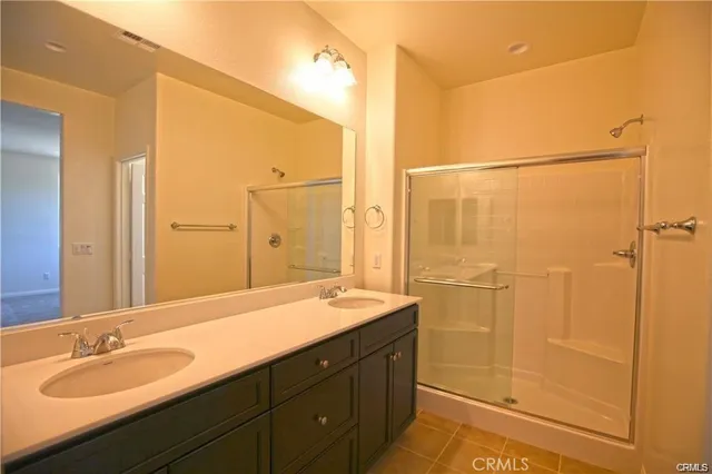 a bathroom with a double vanity sink and mirror