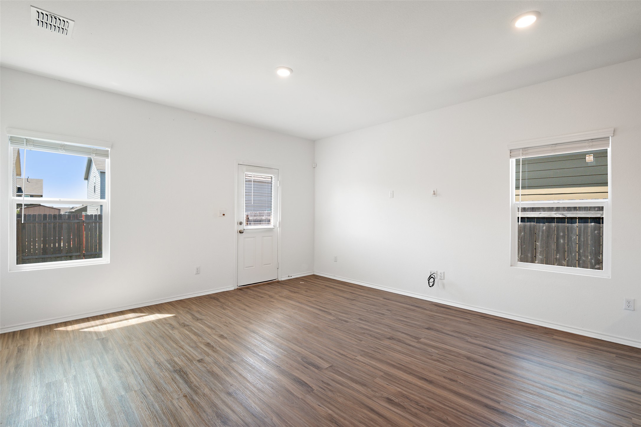 13803 Tordillo Drive Elgin, TX 78621 - Photo 10 of 39 Spare room featuring dark wood-style floors and recessed lighting