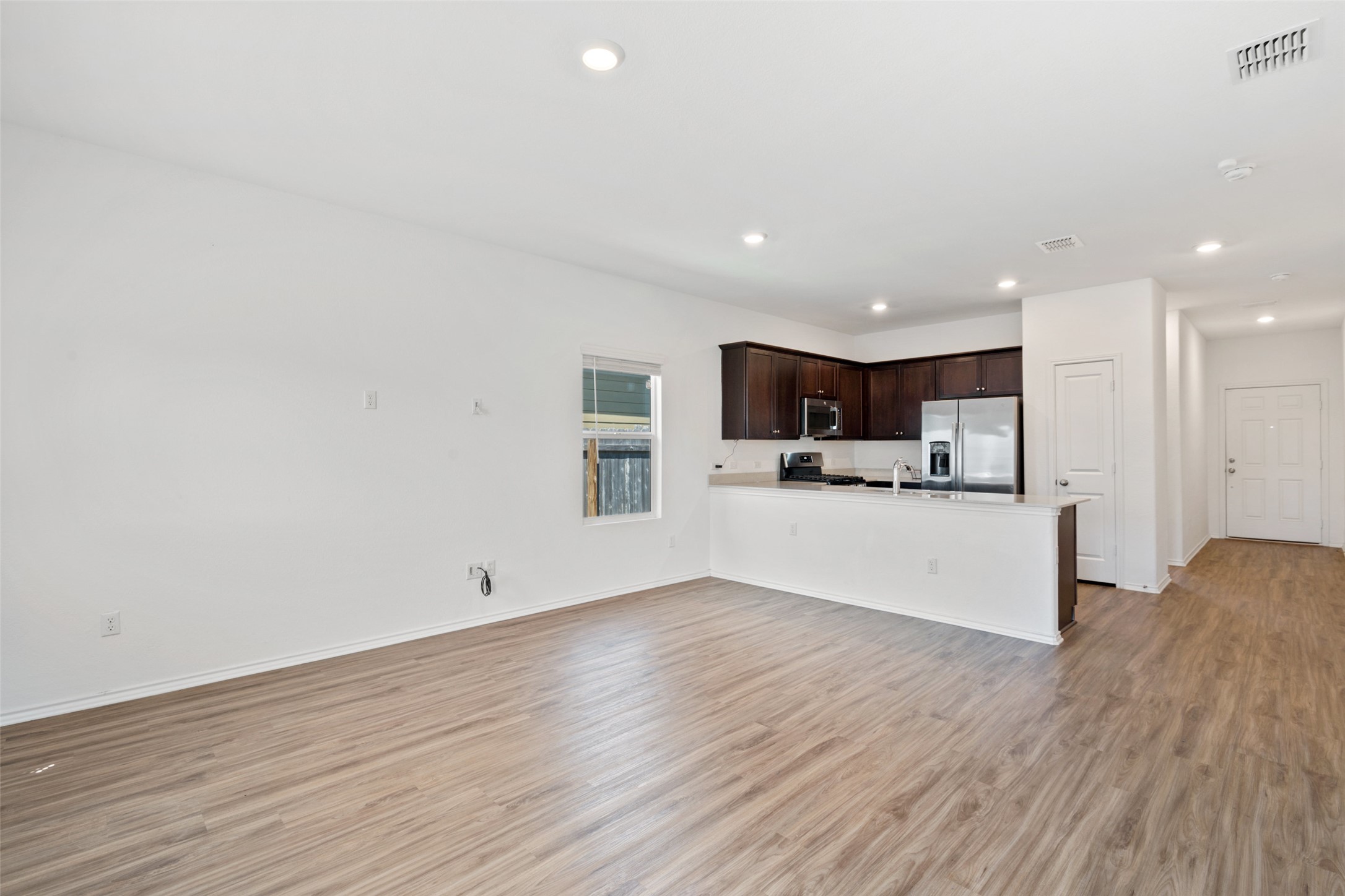 13803 Tordillo Drive Elgin, TX 78621 - Photo 11 of 39 Unfurnished living room featuring light wood finished floors and recessed lighting