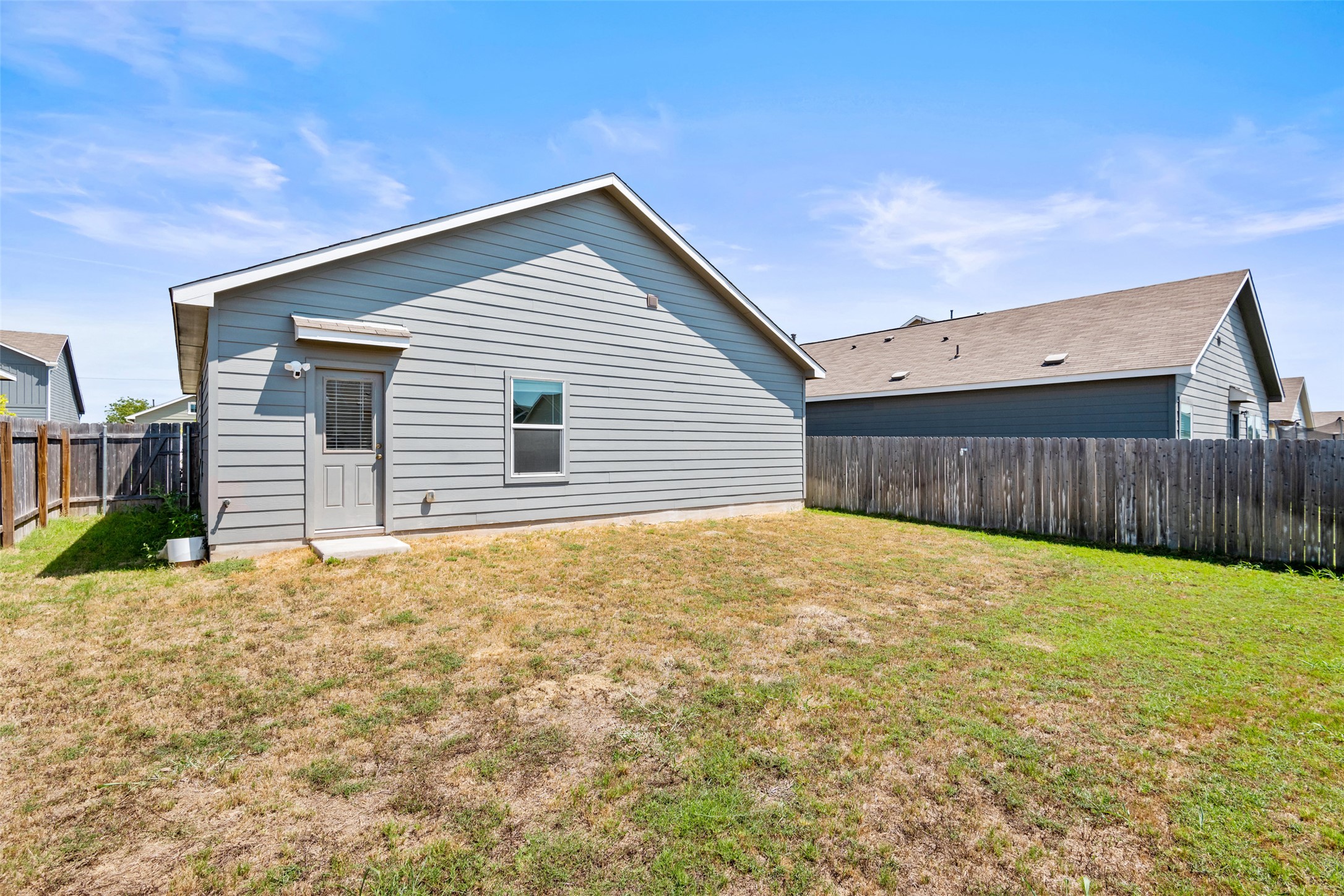 13803 Tordillo Drive Elgin, TX 78621 - Photo 23 of 39 Rear view of property with a fenced backyard