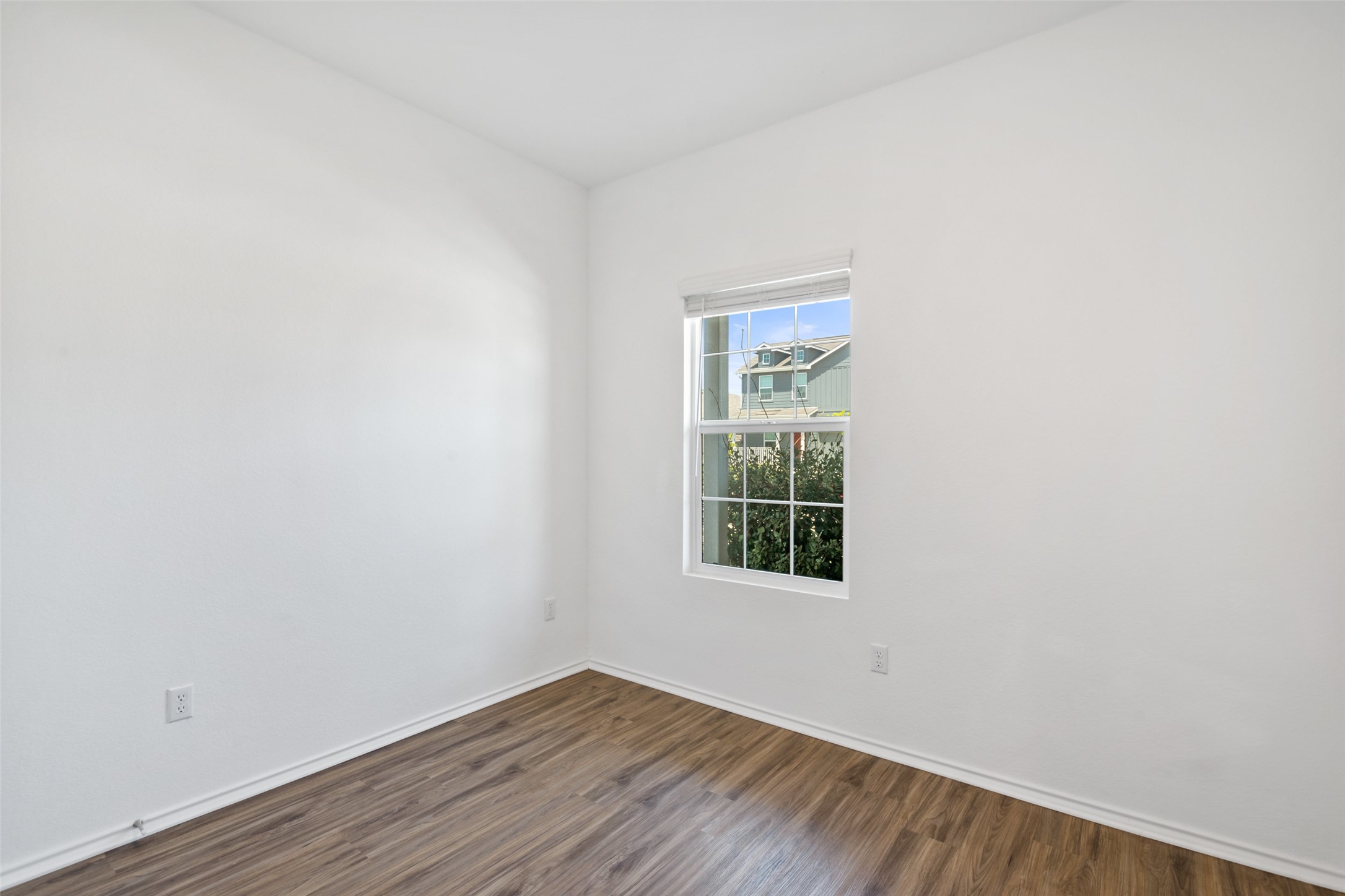 13803 Tordillo Drive Elgin, TX 78621 - Photo 24 of 39 Unfurnished room featuring wood finished floors and baseboards