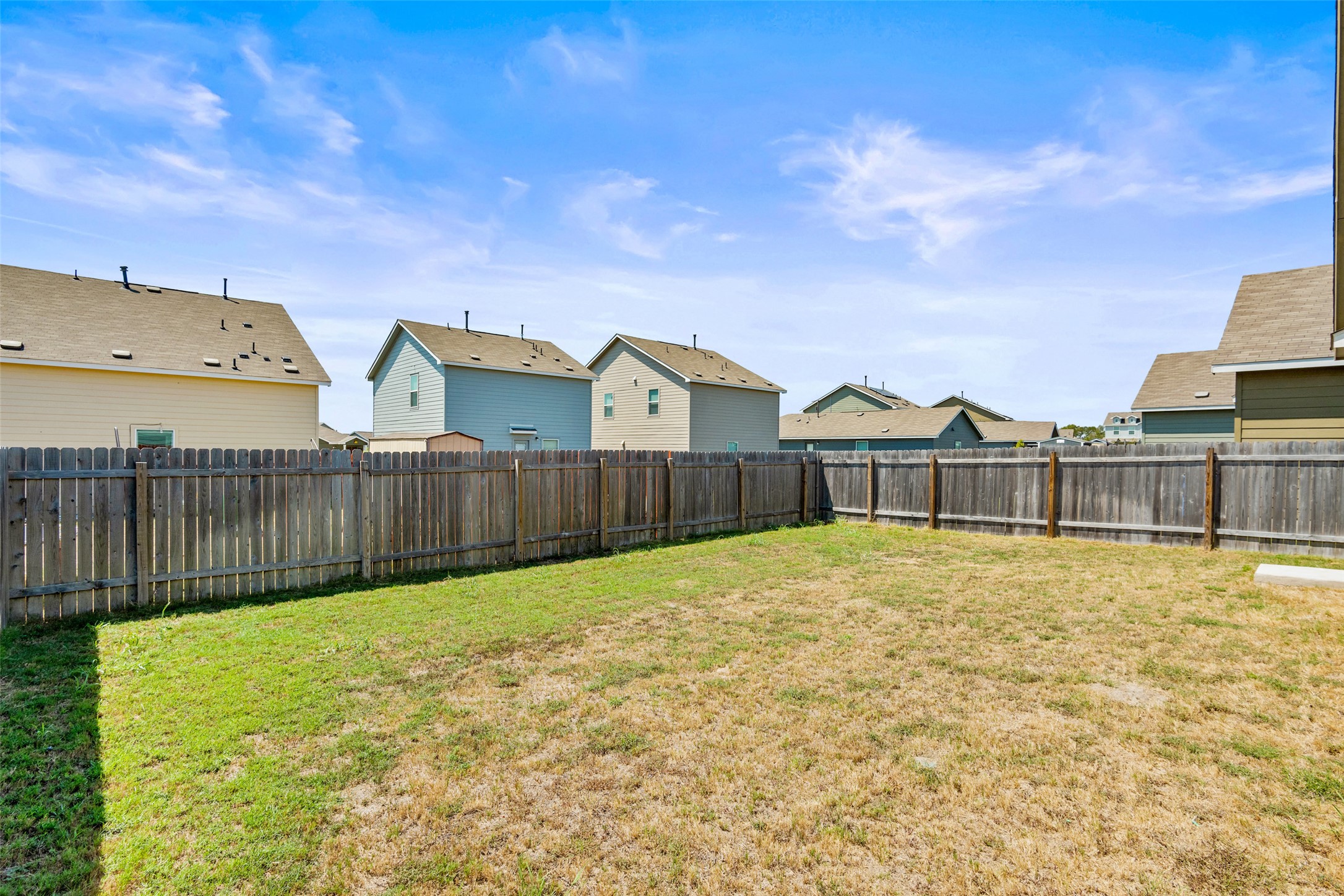 13803 Tordillo Drive Elgin, TX 78621 - Photo 25 of 39 Fenced backyard with a residential view