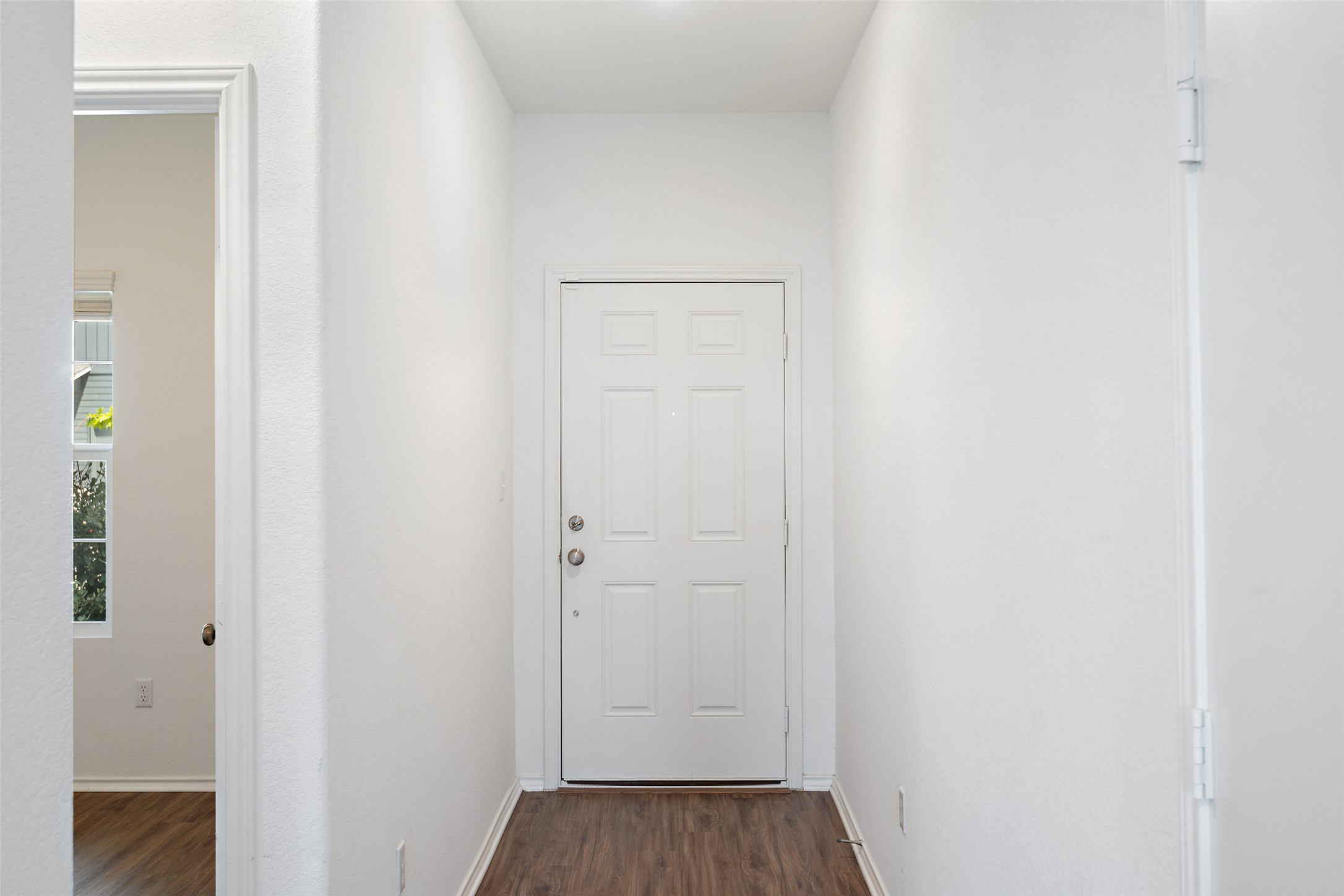 13803 Tordillo Drive Elgin, TX 78621 - Photo 3 of 39 Corridor featuring dark wood-type flooring and baseboards