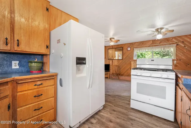 a kitchen with a refrigerator and a stove
