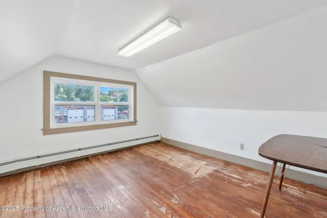 a view of room with window and hardwood floor