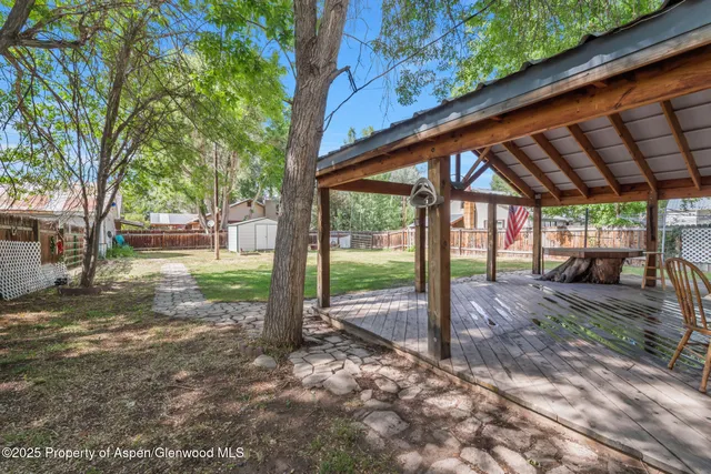 a view of a house with backyard from a patio