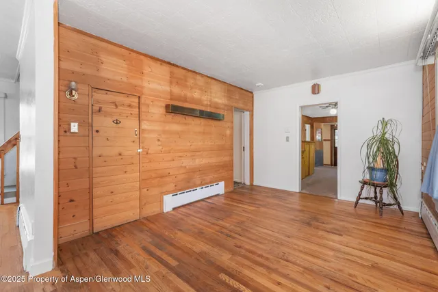 a view of empty room with wooden floor