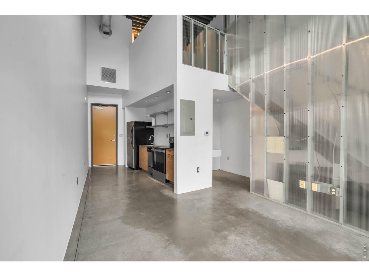 3457 Ringsby Court, Unit 327 Denver, CO 80216 - Photo 7 of 29 a view of an entryway with wooden floor