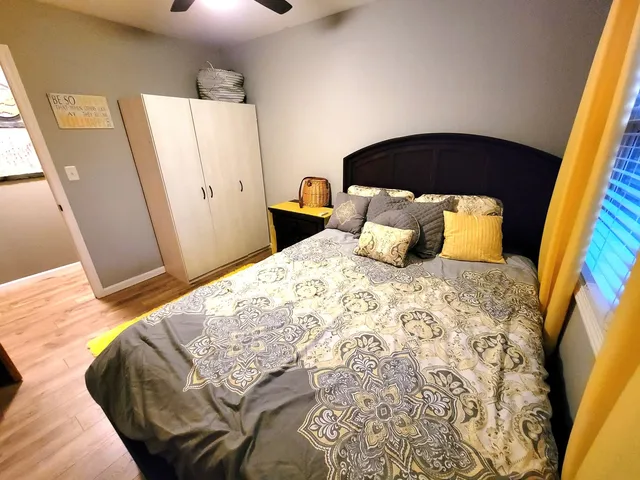 a bedroom with a bed and a mirror