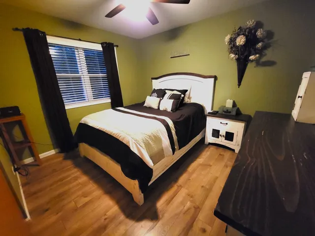 a bedroom with a bed dresser and a window