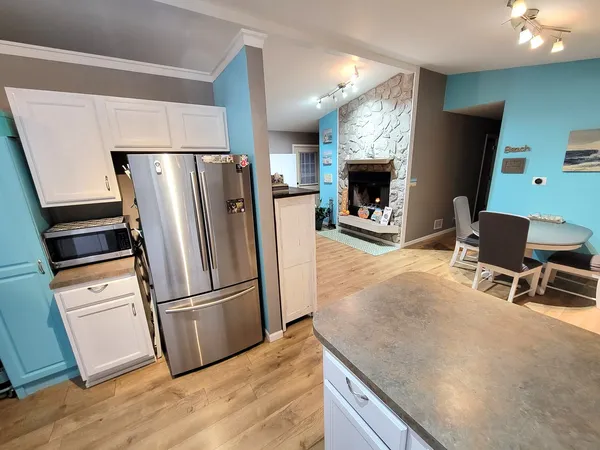 a kitchen with stainless steel appliances a refrigerator and a stove top oven